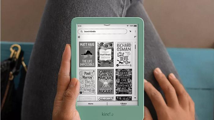 A hand holding a tablet with a black-and-white screen.