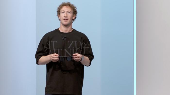 Mark Zuckerberg on stage at Meta Connect 2024 holding the Orion AR smart glasses 