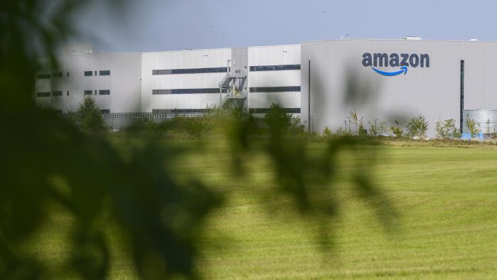This photograph shows the logo of US multinational company Amazon displaying on the facade of the distribution centre in Augny, near Metz, eastern France, on August 29, 2024. The Augny site, equipped with cutting-edge technology which guarantees the safety and well-being of employees, covers 180,000 square metres and employs around 4,000 people. Amazon reintroduces consumer visits that had been interrupted during COVID19, to rehabilitate its image, damaged by criticism of working conditions in its warehouses. (Photo by Jean-Christophe VERHAEGEN / AFP) (Photo by JEAN-CHRISTOPHE VERHAEGEN/AFP via Getty Images)