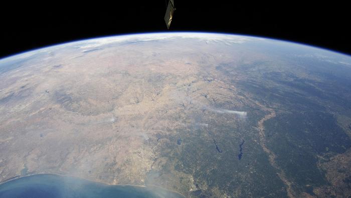 A panoramic view taken by astronauts aboard the International Space Station (ISS) of east-central Texas on September 6, 2011, highlights numerous smoke plumes caused by wildfires burning across the state. Smoke plumes are clearly visible to the east of Austin; to the north of Houston; to the northwest of Lake Sam Rayburn and Toledo Bend Reservoir; and to the west of Shreveport, Louisiana. Diffuse smoke is moving offshore into the Gulf of Mexico at image bottom. Part of an ISS photovoltaic radiator panel is visible at image top center. Picture taken September 6, 2011. REUTERS/Nasa Earth Observatory/Handout (ENVIRONMENT) FOR EDITORIAL USE ONLY. NOT FOR SALE FOR MARKETING OR ADVERTISING CAMPAIGNS. THIS IMAGE HAS BEEN SUPPLIED BY A THIRD PARTY. IT IS DISTRIBUTED, EXACTLY AS RECEIVED BY REUTERS, AS A SERVICE TO CLIENTS