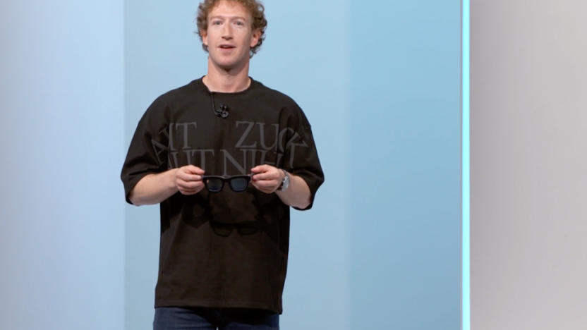 Mark Zuckerberg onstage, holding a pair of glasses, at Meta Connect 2024.
