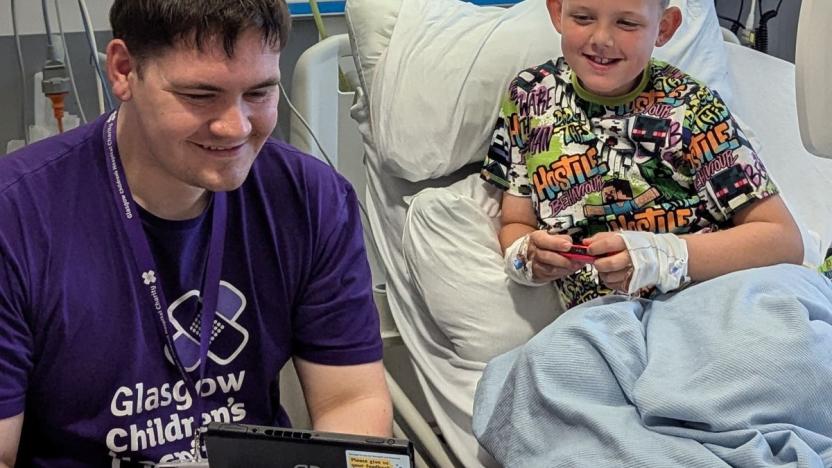 Gamer-in-Residence, Steven Mair (26) plays with eight-year-old patient Martin at the Royal Hospital for Children in Glasgow, Scotland.